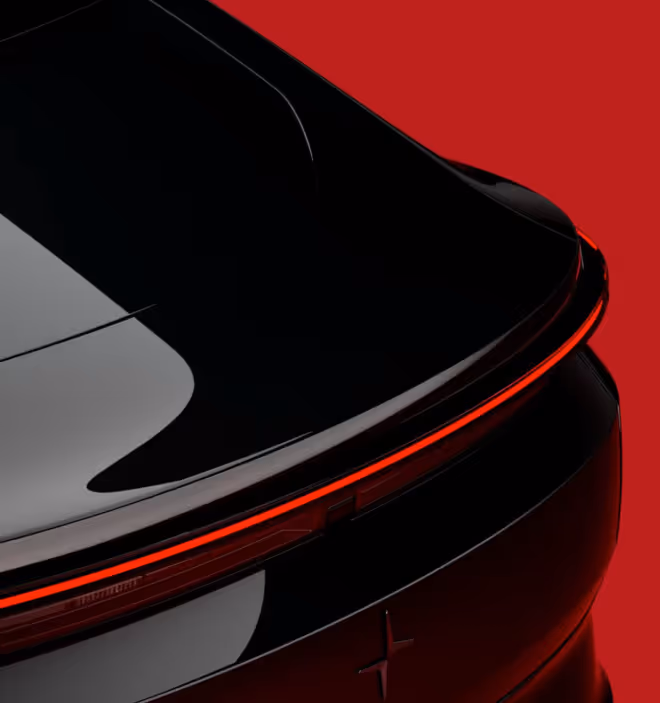 Rear view of a black car with a sleek continuous red taillight against a red background.
